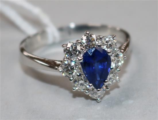 A sapphire and diamond cluster ring, 18ct white gold shank, size V.
